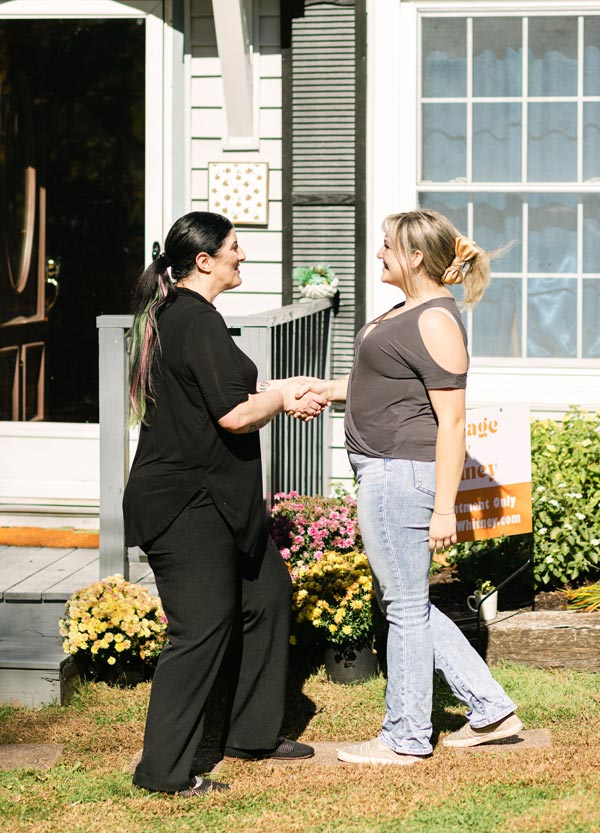 Massage Therapist, Whitney Laws, greeting her new client.