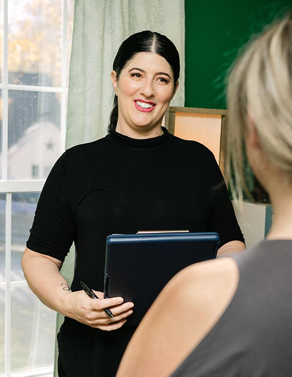 Whitney Laws, owner of Massage by Whitney meeting with a client before her massage session begins.